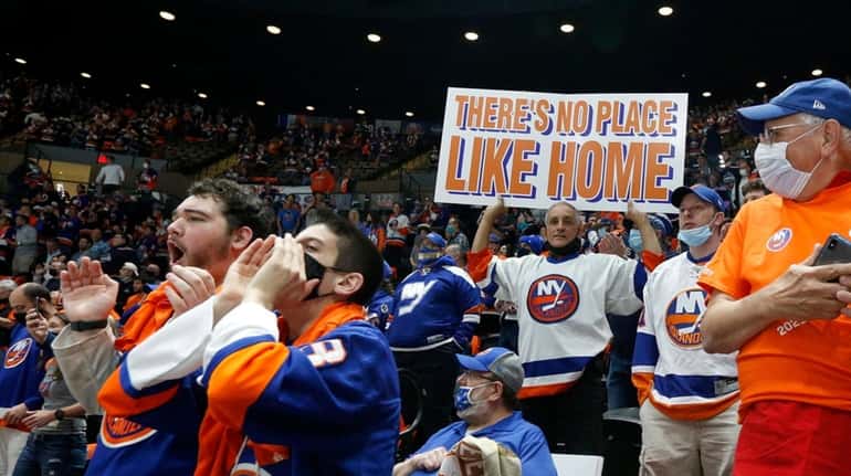 Fans cheer before the Islanders play against the Pittsburgh Penguins in...