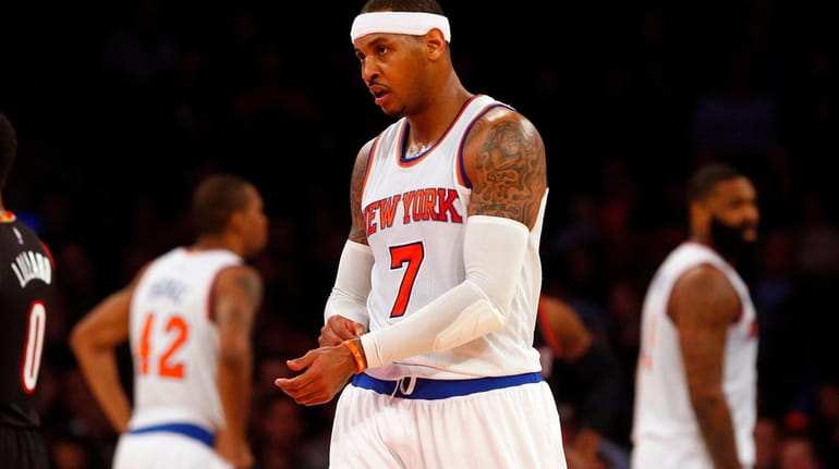 Carmelo Anthony of the New York Knicks looks on against...