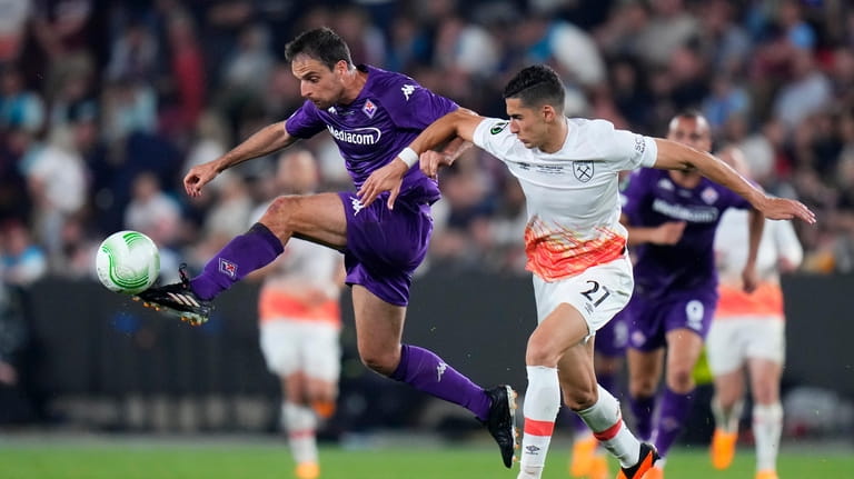 West Ham's Nayef Aguerd vies for the ball with Fiorentina's...