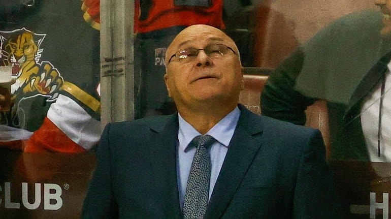 Head coach Barry Trotz of the Islanders watches a replay during...