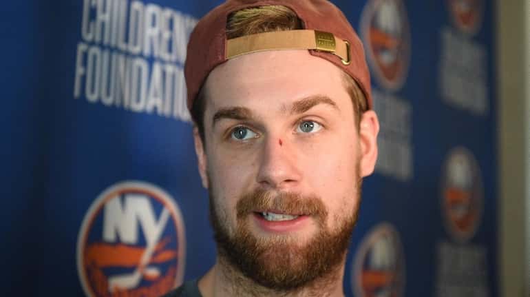 New York Islanders defenseman Calvin de Haan answers questions from...