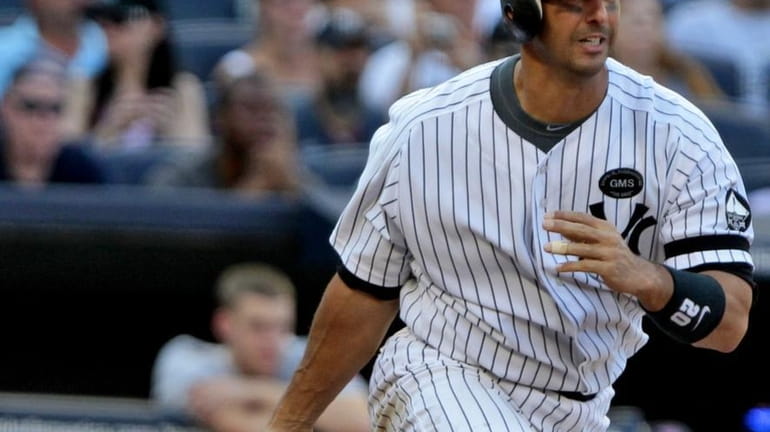 New York Yankees' Jorge Posada follows through on an RBI...