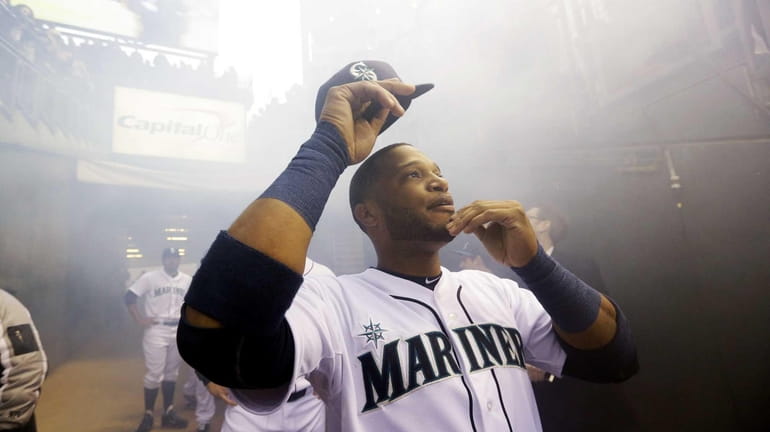 Seattle Mariners' Robinson Cano looks up as he prepares to...