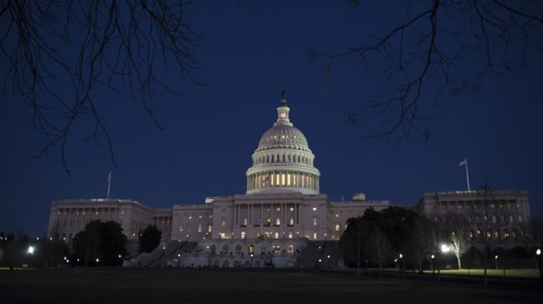 The Capitol is seen illuminated in Washington on Friday evening,...