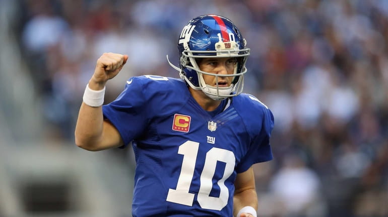Eli Manning celebrates a touchdown by Henry Hynoski during a...