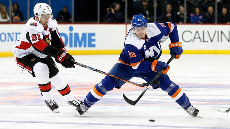 Mathew Barzal #13 of the New York Islanders skates with...