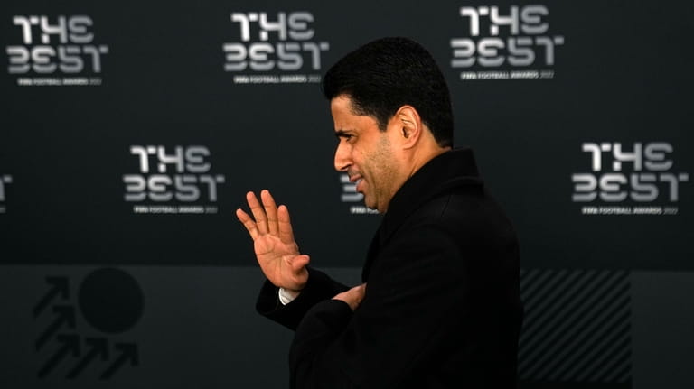 PSG chairman Nasser Al-Khelaifi waves as he arrives on the...