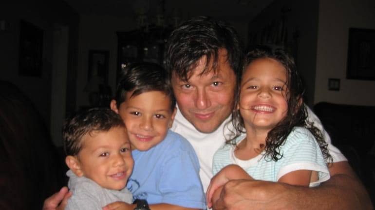 Mike Mangianello, pictured with his three children, Johnny, Michael and...