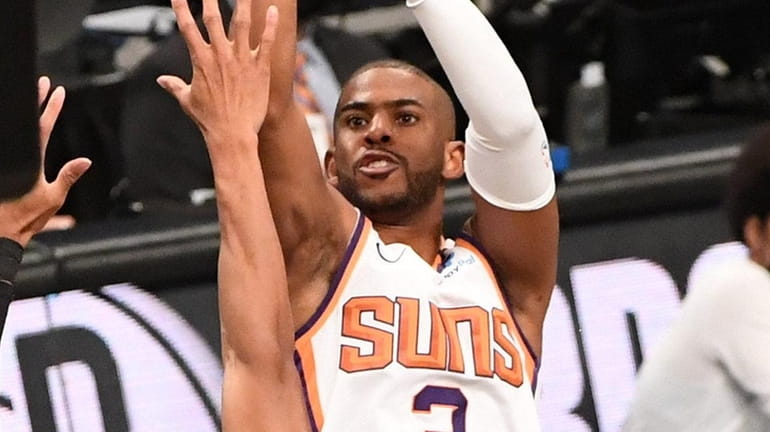 Phoenix Suns guard Chris Paul shoots over Brooklyn Nets forward...