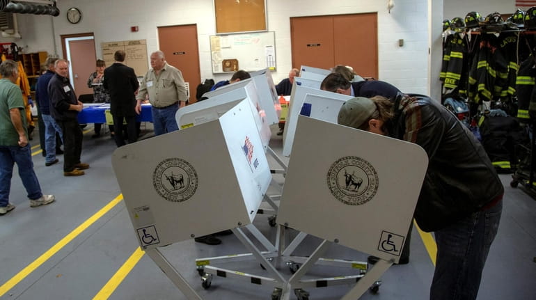Voters cast their ballots at the Eatons Neck Fire Department...
