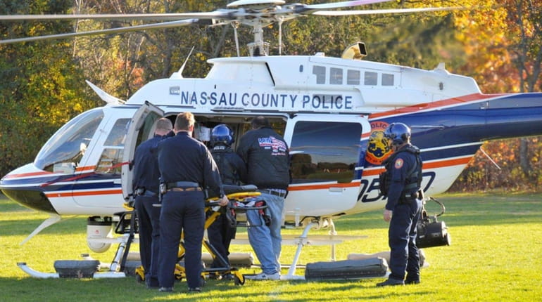 A Nassau police aviation unit helicopter transports an injured motorist...