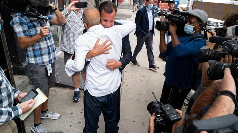 Rep. Tom Suozzi (D-Glen Cove) embraces Mohammad Wali Wednesday outside the Plainview...