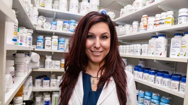 Pharmacist Saira Kahn stands inside Sun Ray Pharmacy in Bay...