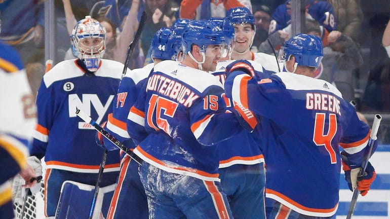 The Islanders celebrate after defeating the Blues at UBS Arena on...