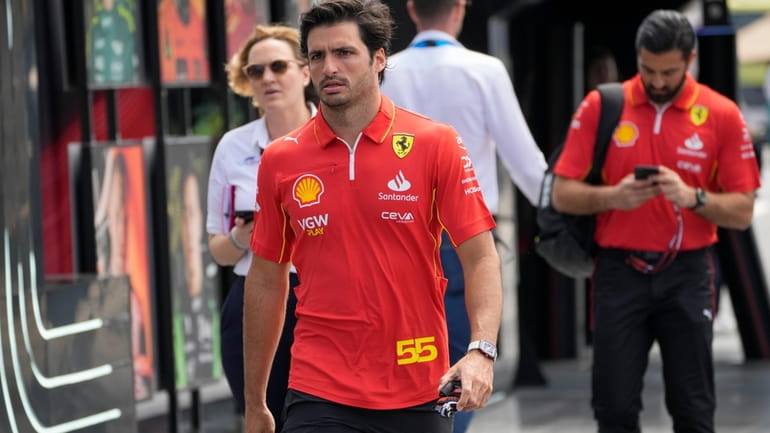 Ferrari driver Carlos Sainz of Spain arrives to the paddock...