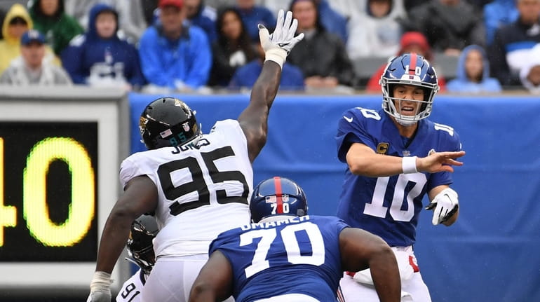 Eli Manning throws an interception that was returned for a...