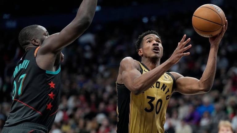 Toronto Raptors guard Ochai Agbaji (30) goes to the basket...