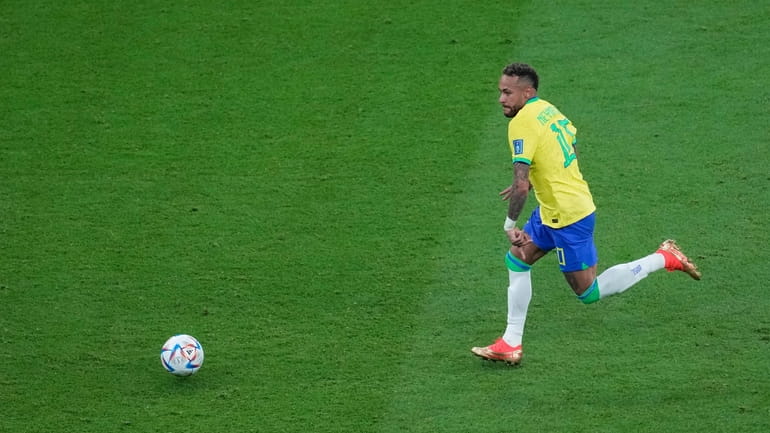 Brazil's Neymar, runs for the ball during the World Cup...