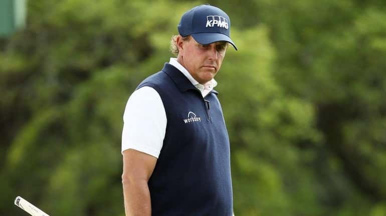 Phil Mickelson reacts on the 18th green during the second...