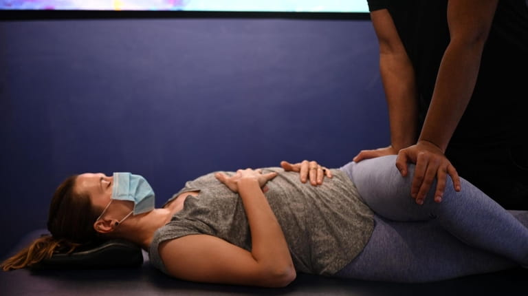 Monika Bartocha of Huntington has a stretching session with flexologist...