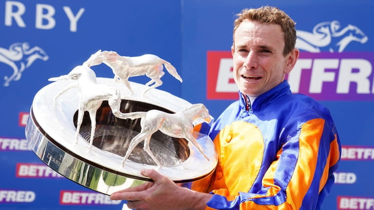 Ryan Moore poses with The Derby Trophy after winning the...