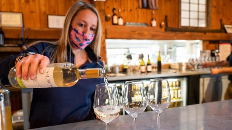 Rachel Sunday pours samples of wine at Jamesport Vineyards in...