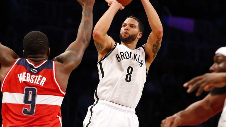 Deron Williams of the Nets shoots a three-point basket in...