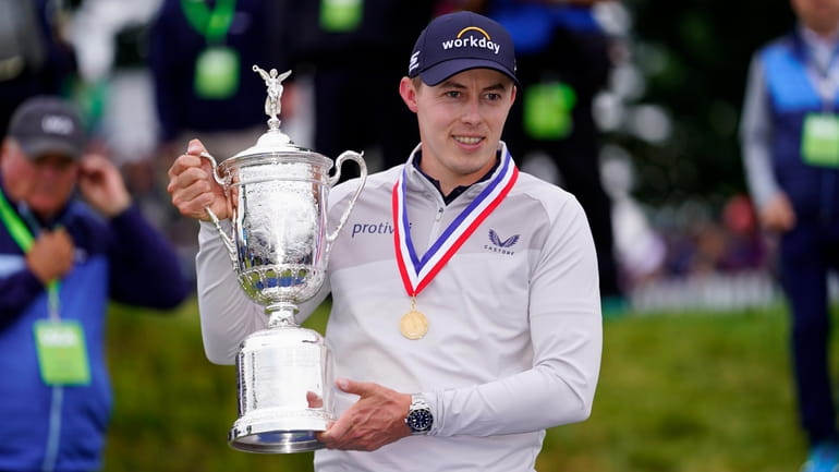 Matthew Fitzpatrick poses with the trophy after winning the U.S. Open at...