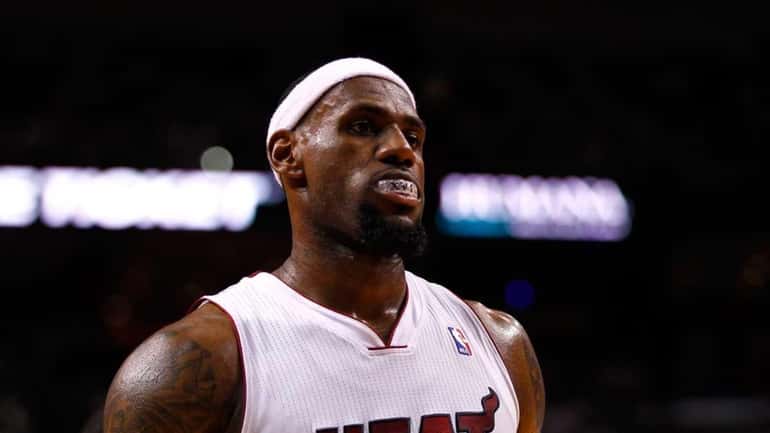 LeBron James #6 of the Miami Heat looks on against...