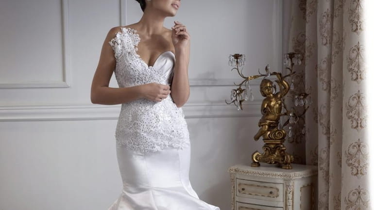 This Marina K Couture bridal gown is featured at a...