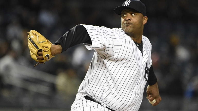 New York Yankees starting pitcher CC Sabathia delivers in the...