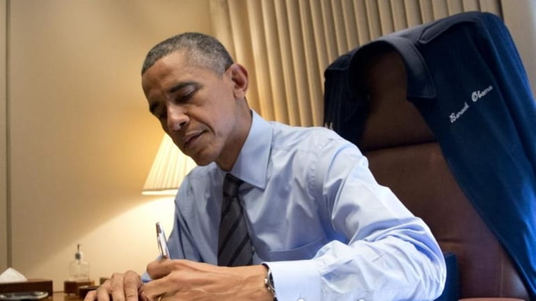 President Barack Obama signs two presidential memoranda associated with his...