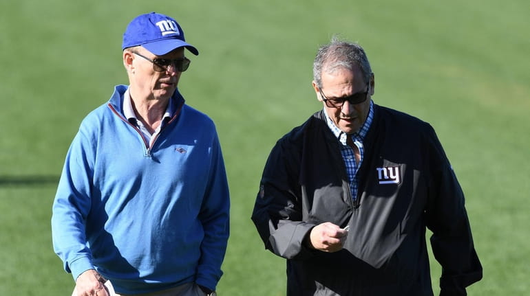 Giants president and CEO John Mara, left, and general manager...