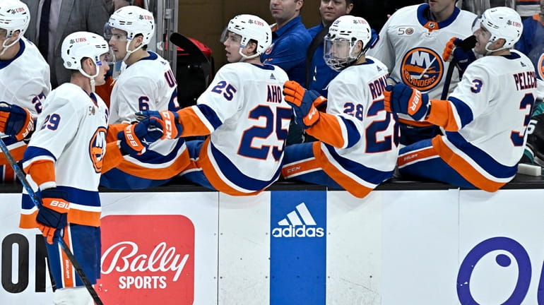 New York Islanders center Brock Nelson, left, is congratulated after...