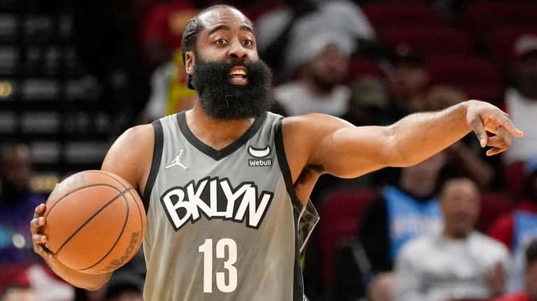 Nets guard James Harden gives instructions during the first half...