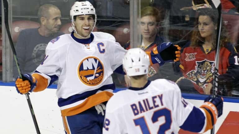 New York Islanders' John Tavares, left, celebrates with teammate Josh...