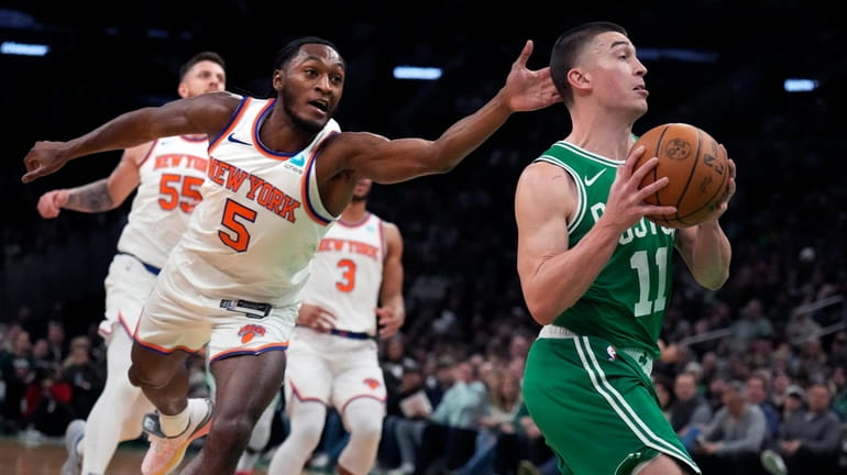 Boston Celtics guard Payton Pritchard (11) drives to the basket...