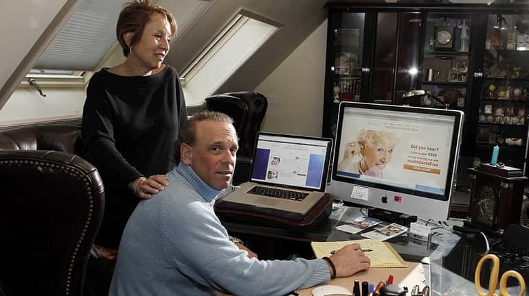 Deborah and Charles Eisenson show a visitor the website of...
