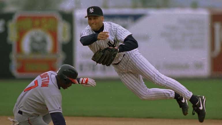 Derek Jeter tries to turn a double play as Kenny...