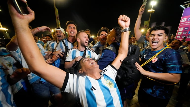 Supporters from Argentina celebrate outside Lusail Stadium following their team's...