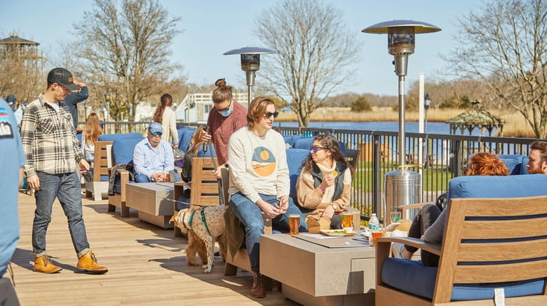 Patrons enjoy outdoor dining at Peconic County Brewing in Riverhead.