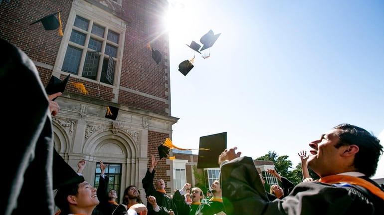 The graduates celebrate after their commencement ceremony at Webb Institute...
