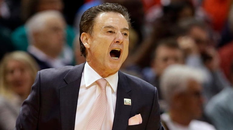 Louisville head coach Rick Pitino yells to his team from...
