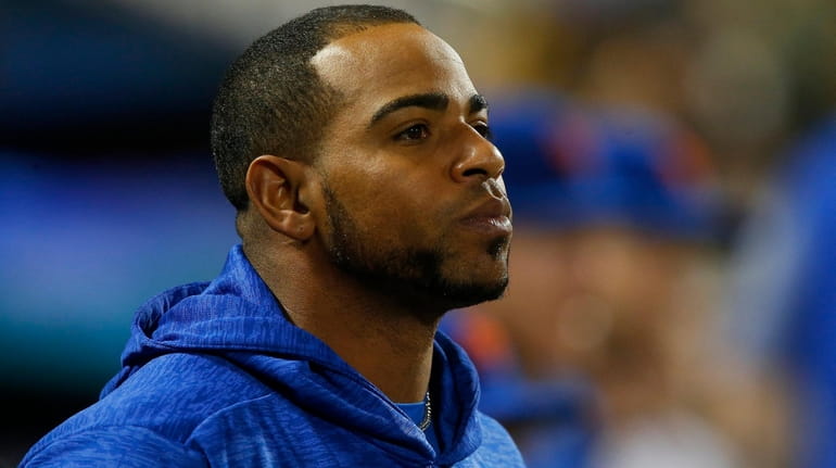 Yoenis Cespedes of the Mets looks on from the dugout...