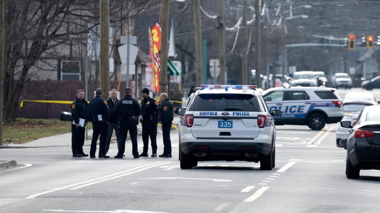 Police officers at the scene in East Islip where the...