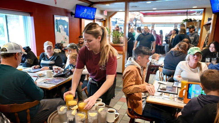 Waitress Rachel Gurcik serves customers at the Gateway Diner in...
