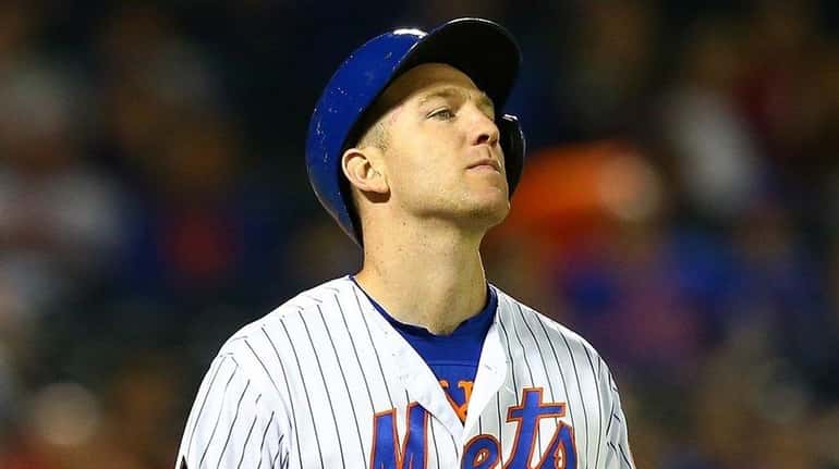 Todd Frazier of the Mets reacts after hitting into a...