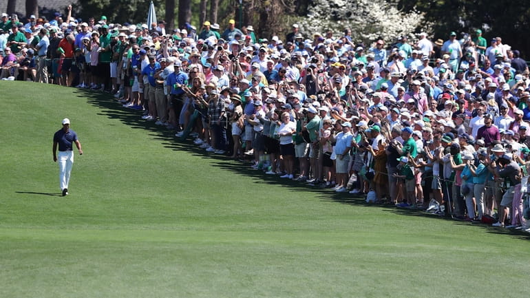 The giant gallery of patrons following five-time Masters champion Tiger...