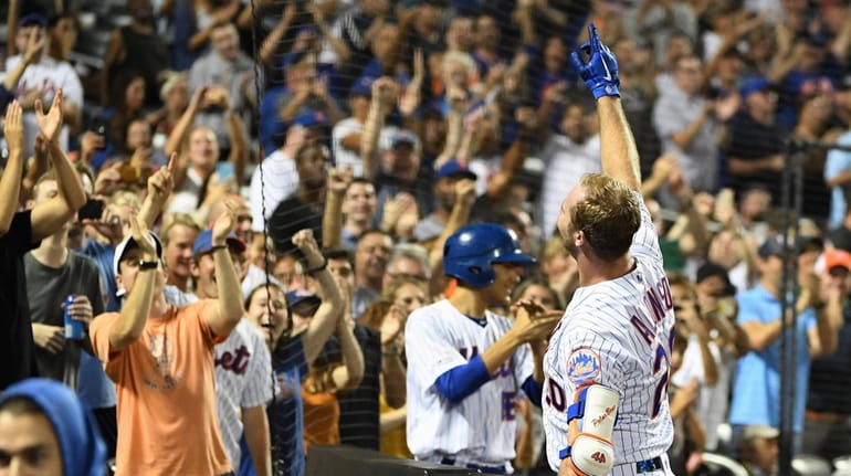 Mets' Pete Alonso reacts to fans after he scores on...