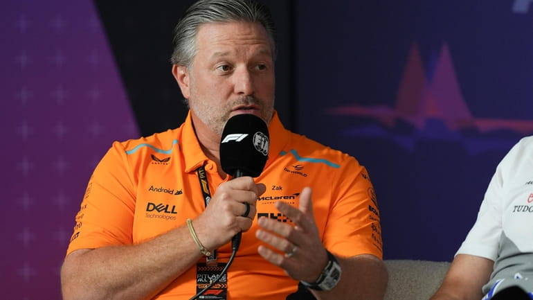 McLaren's Zak Brown gestures during a press conference at the...